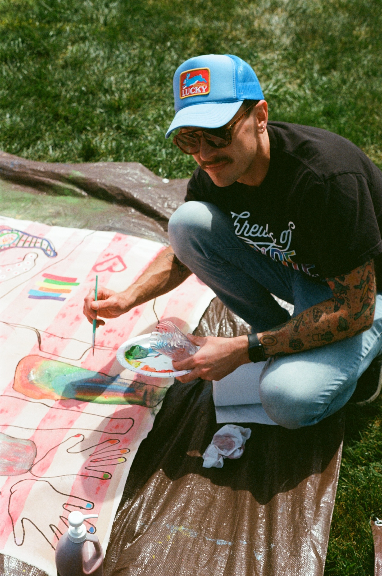 Michael K. Davenport painting a Surface/Self canvas outdoors.
