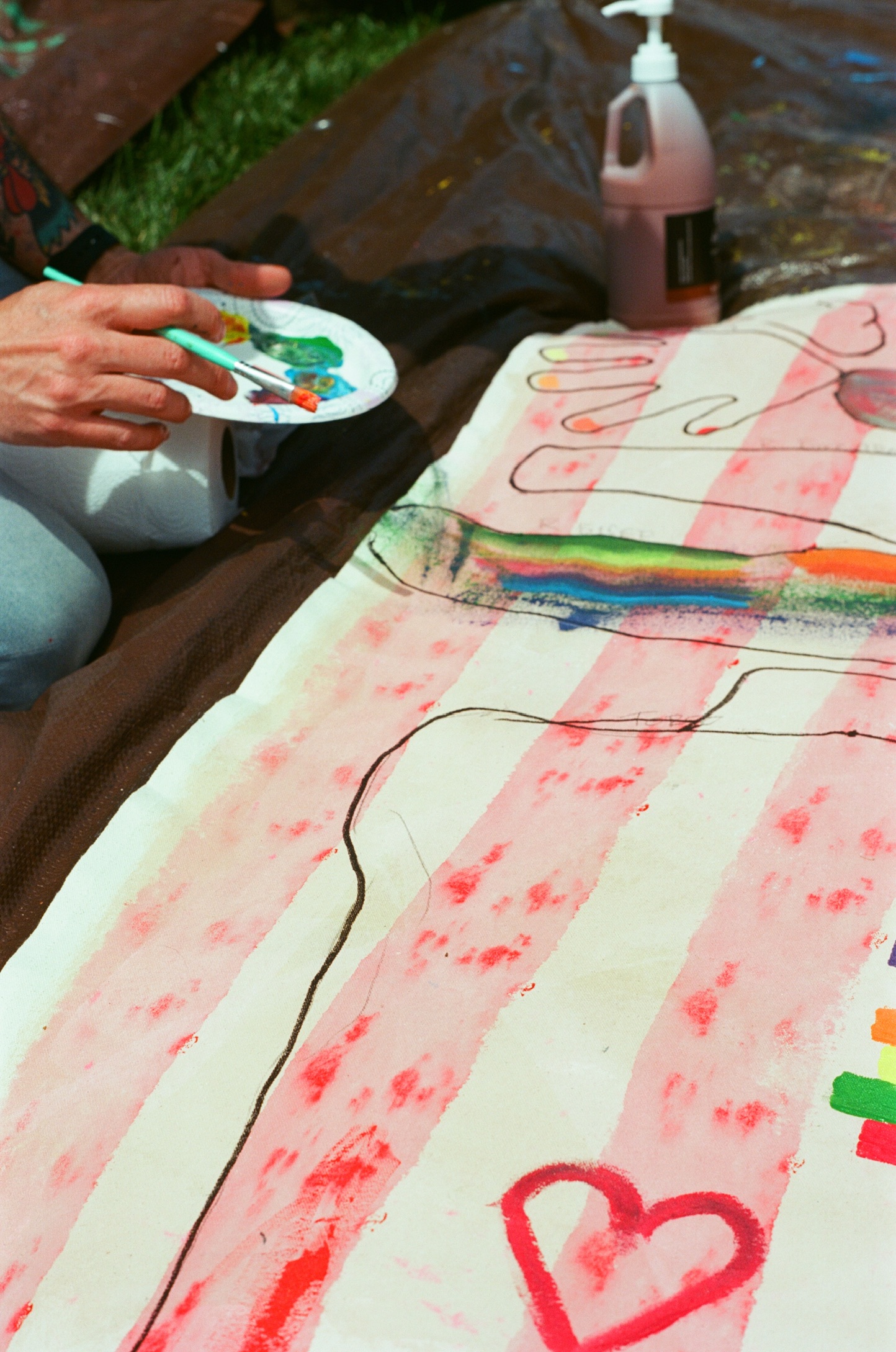 A hand painting rainbow color on a Surface/Self canvas.