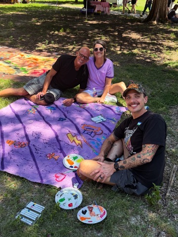 Michael K. Davenport and participants sitting with a purple Surface/Self canvas.